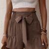 fancy Women's Casual Solid Color Tie Bowknot Smocked Ruffle Hem Elastic Waist Paperbag Shorts - DEEP COFFEE M